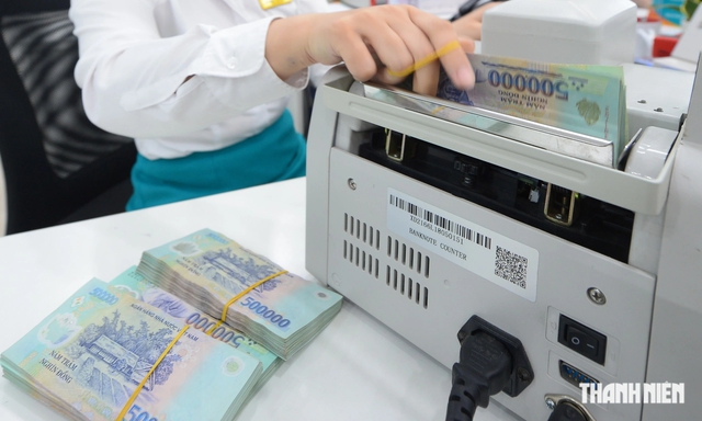 Hơn 20 ngân hàng giảm lãi suất tiết kiệm- Ảnh 1.